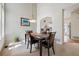 Elegant dining area with a modern chandelier, open layout, and view into the kitchen at 604 S Yarrow St, Lakewood, CO 80226