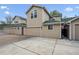Tan townhome featuring three garages, tan siding, a green roof and landscaped surroundings at 604 S Yarrow St, Lakewood, CO 80226