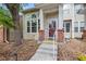 View of the front door of a charming home with brick accents and well-maintained landscaping at 604 S Yarrow St, Lakewood, CO 80226