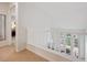 Upstairs hallway with white railing overlooking the living room and front entry at 604 S Yarrow St, Lakewood, CO 80226