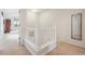Hallway with a white railing and beige carpet at 604 S Yarrow St, Lakewood, CO 80226