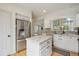 Kitchen features white cabinets, stainless steel appliances, tile backsplash and countertops, plus the island has storage at 604 S Yarrow St, Lakewood, CO 80226