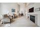 Spacious living room with high ceilings, a cozy fireplace, and comfortable seating arrangement at 604 S Yarrow St, Lakewood, CO 80226