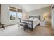 Primary bedroom with vaulted ceiling, two large windows, and metal frame bed at 604 S Yarrow St, Lakewood, CO 80226