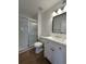 Bathroom featuring a glass shower, modern vanity, and wood-look floors at 943 S Zeno Way # 205, Aurora, CO 80017