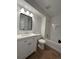 Bright bathroom with hardwood flooring, modern fixtures, vanity sink, and a tub-shower combo at 943 S Zeno Way # 205, Aurora, CO 80017