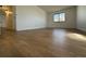 Bedroom with wood-look floors, white walls, and a large window providing ample natural light at 943 S Zeno Way # 205, Aurora, CO 80017