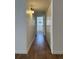 Hallway featuring wood-look floors, white walls and trim, and multiple closets at 943 S Zeno Way # 205, Aurora, CO 80017