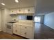 Bright kitchen featuring white cabinetry and modern appliances overlooking the living area at 943 S Zeno Way # 205, Aurora, CO 80017
