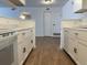 Well-designed kitchen featuring white cabinets, marble countertops, and modern appliances at 943 S Zeno Way # 205, Aurora, CO 80017