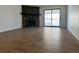Spacious living area featuring a stone fireplace and sliding glass door to the balcony at 943 S Zeno Way # 205, Aurora, CO 80017
