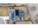 Aerial view of a house with a pool, hot tub, solar panels, and a fenced backyard at 3234 Picketwire Way, Castle Rock, CO 80108