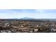 Expansive aerial view of a sprawling neighborhood with mountain views and winding roads at 3234 Picketwire Way, Castle Rock, CO 80108