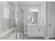 Bright bathroom featuring a glass enclosed shower, and a white single sink vanity at 3234 Picketwire Way, Castle Rock, CO 80108