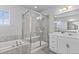 Bright bathroom featuring a glass enclosed shower, soaking tub, and a white double sink vanity at 3234 Picketwire Way, Castle Rock, CO 80108