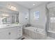 Bright bathroom featuring a glass enclosed shower, soaking tub, and a white single sink vanity at 3234 Picketwire Way, Castle Rock, CO 80108