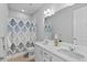 Bright bathroom featuring a decorative shower curtain, double sink vanity, and large mirror at 3234 Picketwire Way, Castle Rock, CO 80108