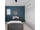Comfortable bedroom featuring a decorative blue wall, and natural light from a window at 3234 Picketwire Way, Castle Rock, CO 80108