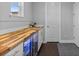 Stylish butler pantry boasting custom wood counters and a wine refrigerator for seamless entertaining and storage at 3234 Picketwire Way, Castle Rock, CO 80108