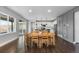 Open concept dining room with wood table and access to kitchen and outdoor patio at 3234 Picketwire Way, Castle Rock, CO 80108