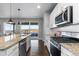 Modern kitchen island with sink and stainless appliances with outdoor access at 3234 Picketwire Way, Castle Rock, CO 80108
