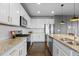 Bright kitchen with stainless steel appliances, white cabinets and granite countertops at 3234 Picketwire Way, Castle Rock, CO 80108