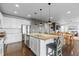 Open-concept kitchen island and bar seating and access to the dining room and living room at 3234 Picketwire Way, Castle Rock, CO 80108