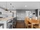Open kitchen with island and stools, wood floors, flows to dining room at 3234 Picketwire Way, Castle Rock, CO 80108