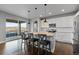 Modern kitchen with stainless appliances, granite countertops, island with seating, and access to patio at 3234 Picketwire Way, Castle Rock, CO 80108