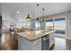 Bright, open kitchen featuring a granite island, modern appliances, and seamless access to the outdoor pool area at 3234 Picketwire Way, Castle Rock, CO 80108