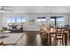 Bright and airy living room connected to dining area with backyard views from large windows at 3234 Picketwire Way, Castle Rock, CO 80108