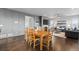 Open-concept dining and living room with wood floors and fireplace, seating area with sofa at 3234 Picketwire Way, Castle Rock, CO 80108