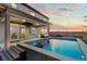 Backyard with modern pool, well-lit deck and sunset views from the covered patio at 3234 Picketwire Way, Castle Rock, CO 80108