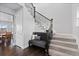 Elegant stairway with wrought iron railing and a cozy bench seating area, offering a stylish and inviting entrance at 3234 Picketwire Way, Castle Rock, CO 80108