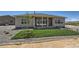 View of backyard with freshly laid sod, stone landscaping, and neutral-colored home at 366 Agoseris Way, Castle Rock, CO 80104