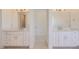 Elegant bathroom featuring dual vanities with white cabinetry, large mirrors, and stylish fixtures at 366 Agoseris Way, Castle Rock, CO 80104