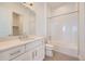 Well-lit bathroom with white cabinets, stone countertops, tiled floors, and a shower and bathtub combo at 366 Agoseris Way, Castle Rock, CO 80104