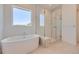 Modern bathroom featuring a soaking tub, glass-enclosed shower, and stylish tile work at 366 Agoseris Way, Castle Rock, CO 80104