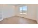 A well lit bedroom with hardwood floors and a large window, overlooking the neighborhood at 366 Agoseris Way, Castle Rock, CO 80104