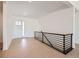 Modern home entryway featuring light hardwood floors and a metal handrail at 366 Agoseris Way, Castle Rock, CO 80104
