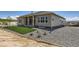 Exterior angle of the home showing a well manicured lawn with grass and stone and partial view of the backyard at 366 Agoseris Way, Castle Rock, CO 80104