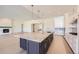 Open kitchen with large island, stainless appliances, and hardwood floors at 366 Agoseris Way, Castle Rock, CO 80104