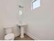 A stylish powder room featuring a pedestal sink, modern fixtures, and a clean aesthetic at 366 Agoseris Way, Castle Rock, CO 80104