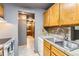 The kitchen has stainless steel sink and tile backsplash, with a view into the bathroom at 4070 S Atchison Way # 101, Aurora, CO 80014