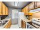 The kitchen features oak cabinets, a white fridge, and ample counter space at 4070 S Atchison Way # 101, Aurora, CO 80014