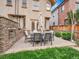 Well-manicured backyard featuring outdoor seating and a stone fireplace at 383 S Franklin St, Denver, CO 80209