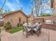 Inviting backyard patio with outdoor dining set, built-in grill, and stone fireplace at 383 S Franklin St, Denver, CO 80209