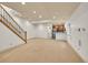 Finished basement featuring a kitchenette, staircase, and neutral carpet at 383 S Franklin St, Denver, CO 80209