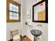 Stylish powder room with unique vessel sink, decorative mirror, and natural light at 383 S Franklin St, Denver, CO 80209