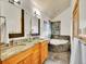 Bathroom featuring double sinks, granite countertop and corner tub at 383 S Franklin St, Denver, CO 80209